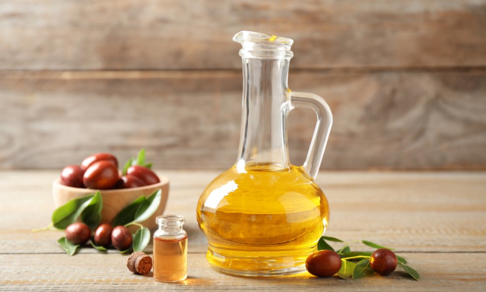 A close-up of jojoba oil, a key ingredient in natural skincare and haircare products, with a soft, glowing background highlighting its nourishing properties.
